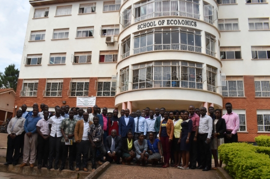 Participants pose for a group photo after the opening session at Makerere University