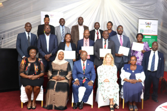 Swedish Ambassodor Maria Hakansson (4th) poses for a group photo with the center Director Edward Bbaale(3rd) and graduands.